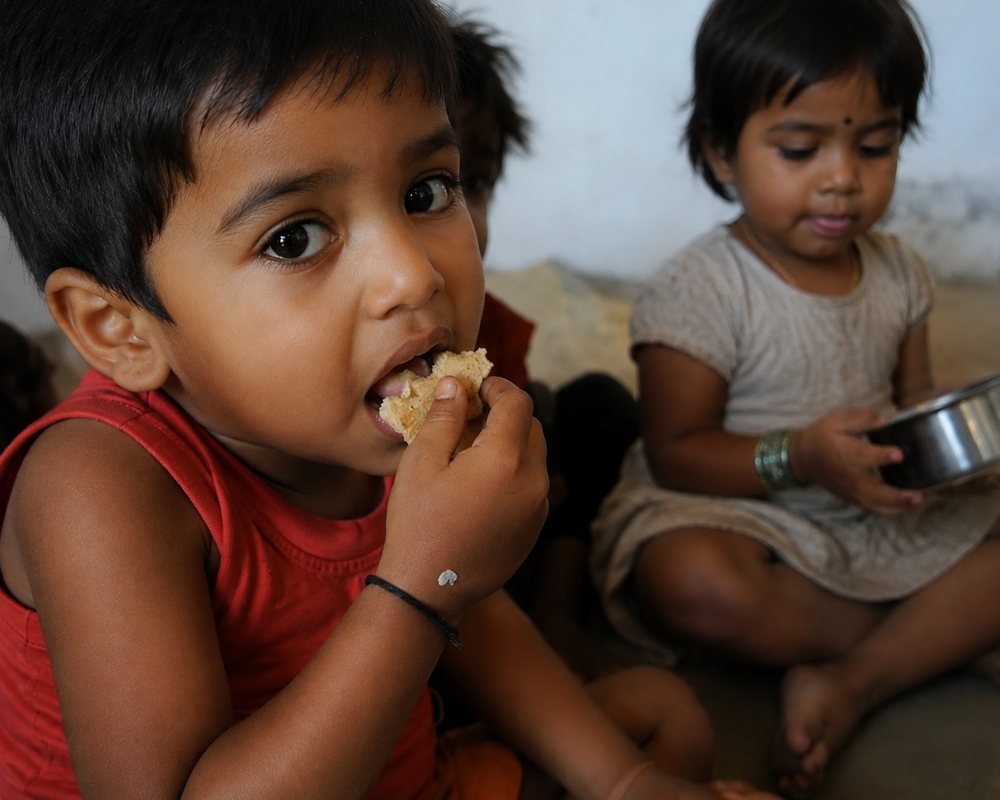 Children eating a hot meal served at a Jeevankriti Foundation food drive