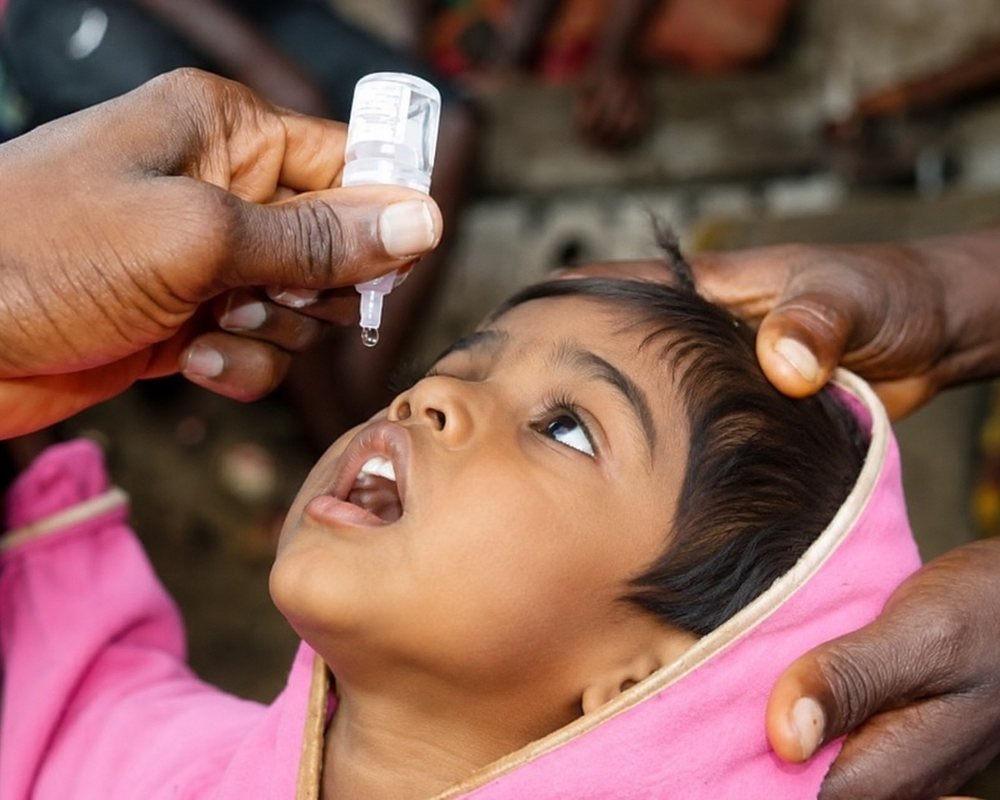 A child being given oral drops at a free Jeevankriti Foundation health camp